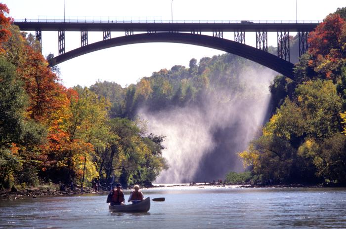 Photograph of people on a canoe along the Genesee River.